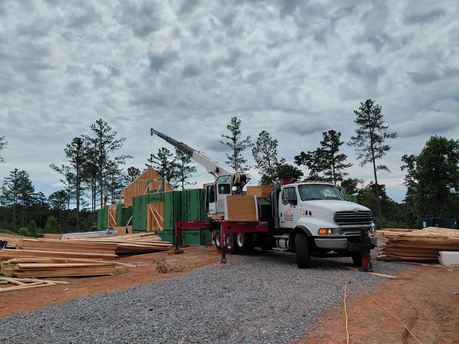 Red tractor truck with lowboy trailer